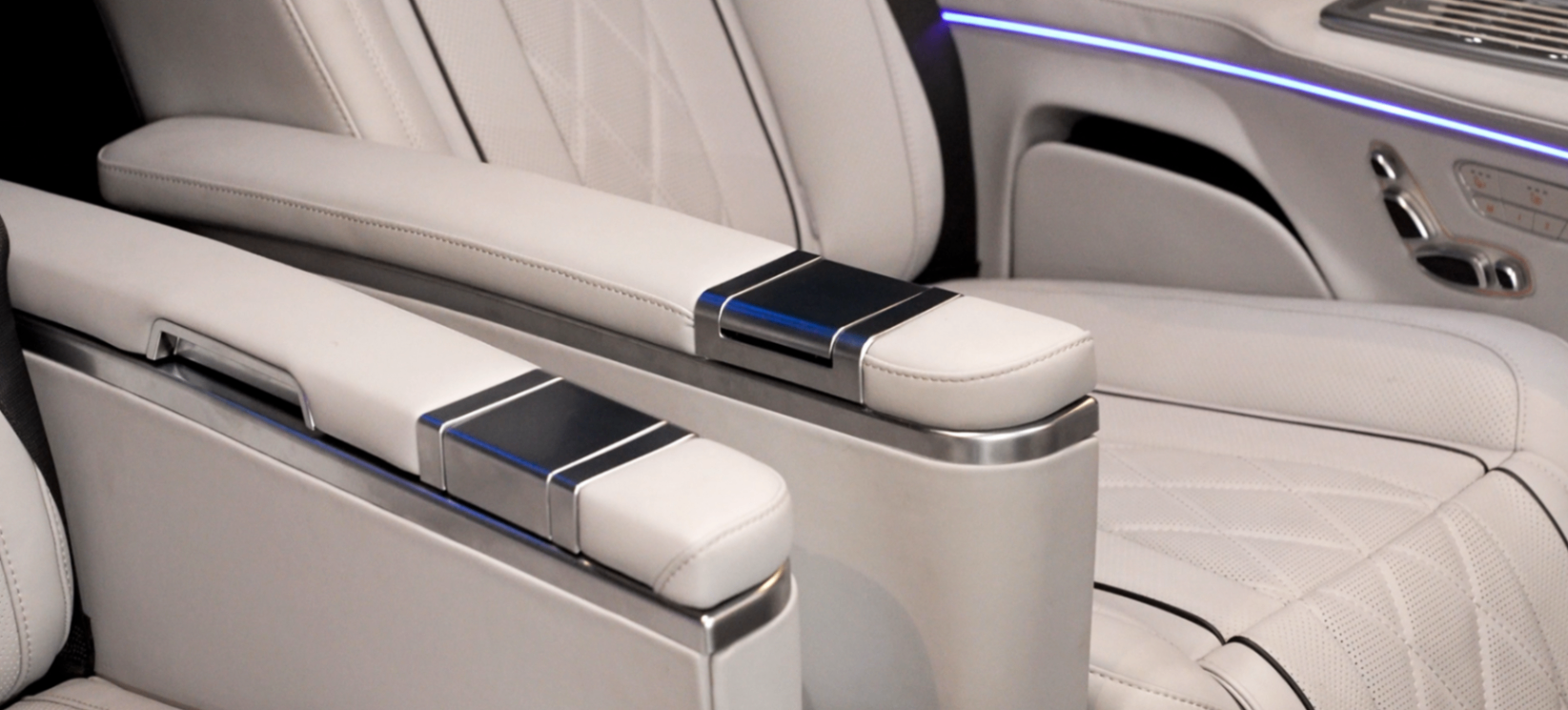 Land Jet armrest and seat console detail in white leather and brushed metal